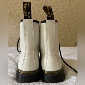 Lightly worn white Dr. Martens boots.